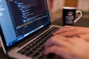 Photo of a man working on IT project risks.