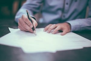 Photo of a man filling out a project charter.