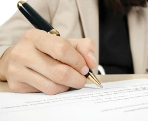Photo of an agilist filling out an agile contract.
